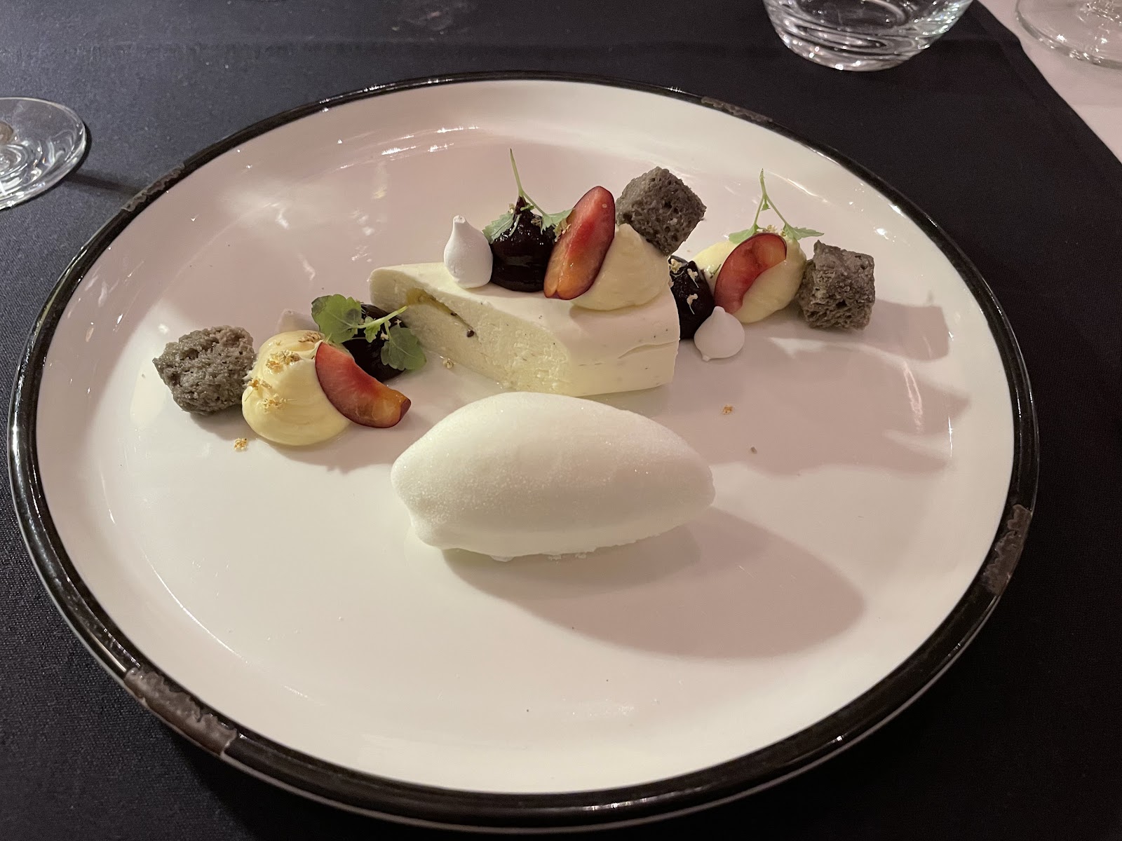 Plated dessert with vanilla parfait, berries and meringue