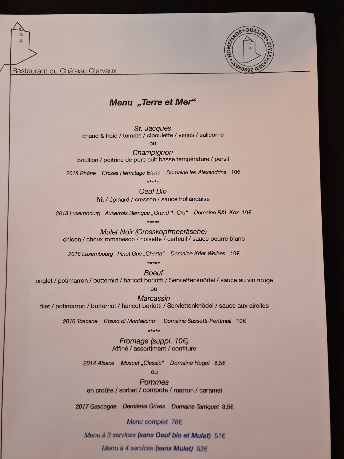 A five-course seasonal tasting menu card photographed at the restaurant